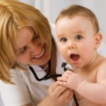 Doctor checking up baby with stethoscope
