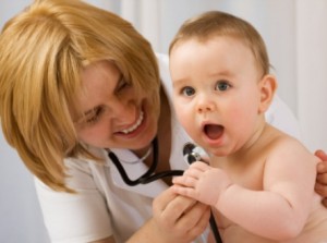 Doctor checking up baby with stethoscope